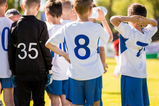 Boy Soccer Player Drinking Water From A Water Bottle During Soccer Half Time Break