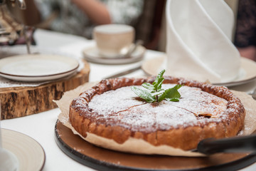 Apples pie with samovar on the served table