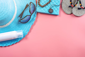 Travel holiday supplies: hat, sunglasses, camera passport and airline tickets on pink background. Top view. Flat lay
