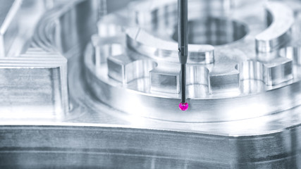 Operator inspection dimension metal parts by CMM after machining process in industrial factory.