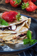 Polish pancakes with jam, cheese and strawberries.