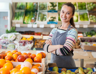 Glad woman store worker in supermarket