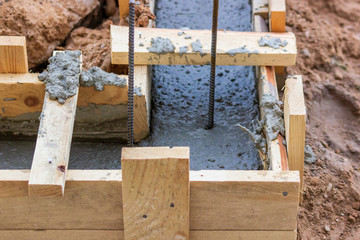 Poured into the formwork the concrete. wooden formwork.