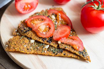 Dry diet crisp breads with sliced tomato on it