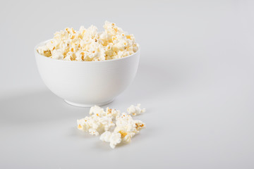 Popcorn in a bowl, isolated on white.