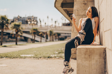 Girl with skates taking selfies in downtown