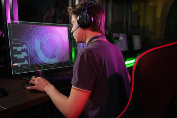 Cyber sport. Fully concentrated professional cybersport player playing important match