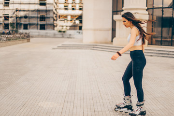 A woman with is rollerblade in summer time