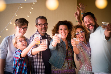 Celebrate people concept with different ages adult and young people toasting all together having...