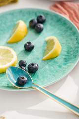 Blueberries and Lemon Slices on Teal Plate