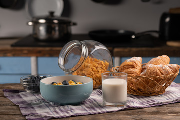 Corn flakes with berry and honey. Fresh croissant. Delicious dessert.