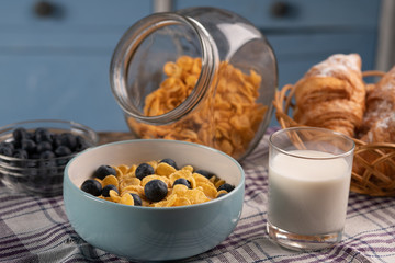 Healthy breakfast. Fresh food. Corn flakes, Croissant, milk, berry on wooden table on the kitchen