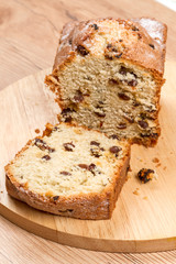 Fototapeta na wymiar Fruit-Cake with raisins on kitchen board
