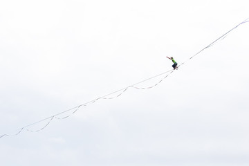 Highline on the background of the cloudy sky makes a move.