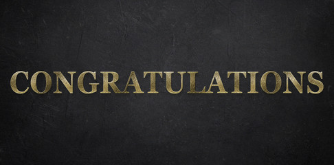 Gold-colored "Congratulations" message on paper background