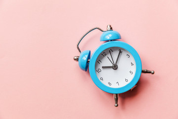 Ringing twin bell vintage classic alarm clock Isolated on pink pastel colorful trendy background....
