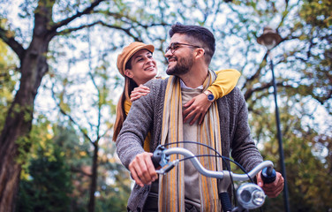 Couple in love. Romantic couple riding a bicycle in the park. Love, dating, romance