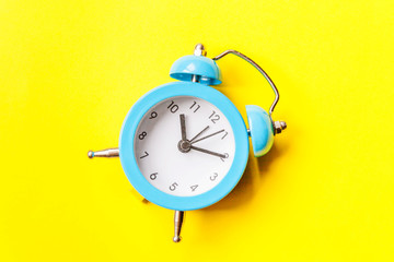 Ringing twin bell vintage classic alarm clock Isolated on yellow colourful trendy modern background. Rest hours time of life good morning night wake up awake concept. Flat lay top view copy space