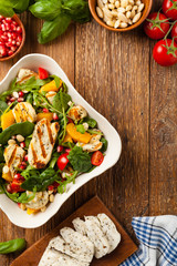 Traditional Greek salad with grilled Halloumi cheese with basil. Top view. Flat lay.