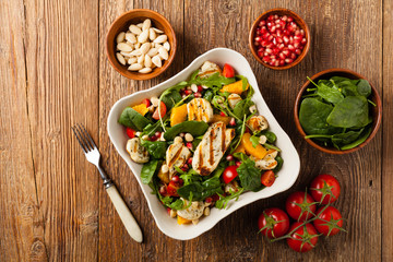 Traditional Greek salad with grilled Halloumi cheese with basil. Top view. Flat lay.
