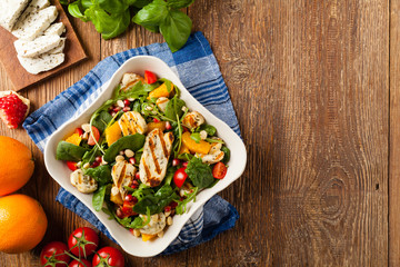 Traditional Greek salad with grilled Halloumi cheese with basil. Top view. Flat lay.