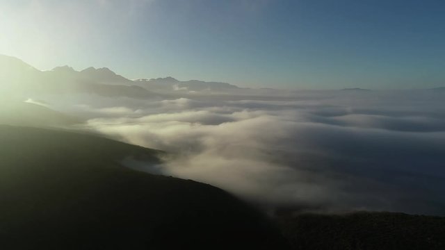 Aerial footage over the Breede Valley in south africa with low fog creating an ethereal feel
