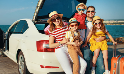 happy large family  in summer auto journey travel by car on beach.