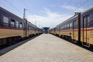 Empty train station apron with electric trains on the sides, Dnipro, Ukraine.