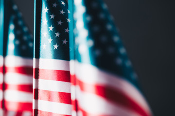 Selective focus of united states of America national flags isolated on black, memorial day concept