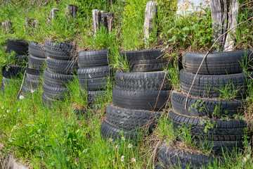 Wheels car as protection in nature. Car tires for shock and flood defense.