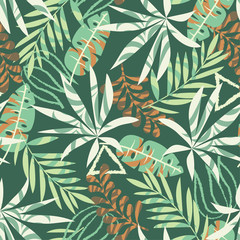 Original seamless pattern with tropical plants and leaves on green background. Vector design. Jungle print. Textiles and printing.