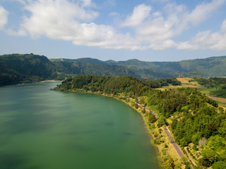 Obraz na płótnie Canvas Aerial view of beautiful Furnas lagoon in the Azores islands. Drone landscape view with lines and textures in the background. Top view of volcanic crater, tourist attraction of Portugal.