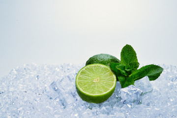 Juicy fresh lime and mint on ice cubes.