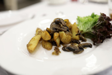 Fried potatoes with mushrooms