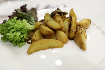 Plate with fried potatoes and mushrooms