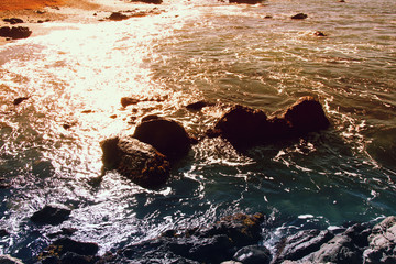sunset on the sea water and rocks