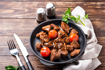 Roasted or stewed beef meat with tomato