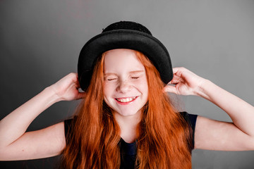 portrait of a red-haired girl in a hat