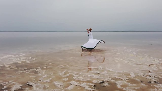 sunset and whirling at the sea, sufi. sufi whirling (Turkish: Semazen) is a form of Sama or physically active meditation which originated among Sufis. 4k