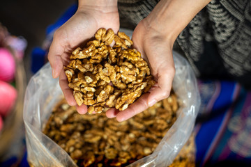 Midsection Of Woman Holding Walnut