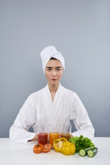 Calm woman after bath with healthy drinks against grey background