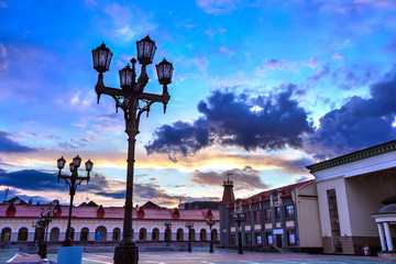 The central city square with beautiful modern architecture for the rest of the locals under a blue sky with colorful clouds. Gostiny Dvor square, Lenina street, Ufa, Bashkortostan, Russia - June 2015.