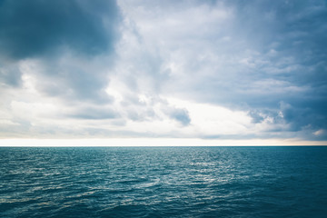 Calm smooth sea and beautiful daytime sky with clouds
