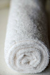 White delicate soft background of fur plush smooth fabric. Clean white towel rolled blanket textile