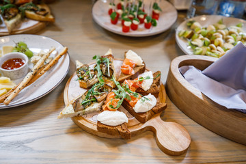 buffet table salmon toast cheese meat fruit honey on the table