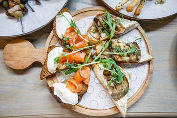 buffet table salmon toast cheese meat fruit honey on the table