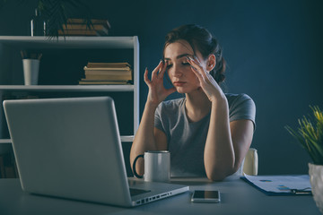 Tired office woman at her desk infront of computer