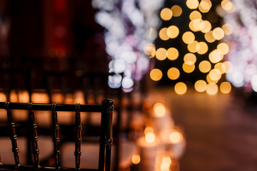 Wedding ceremony decorations in loft grunge surround. Light bulb garland, candles, glass, chairs and candlesticks. Ceremony in purple color. Exit registration inside.