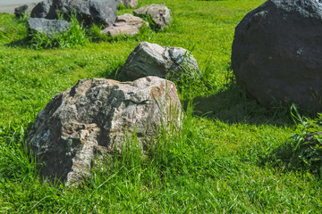 Garden of stones on the green lawn in the park.