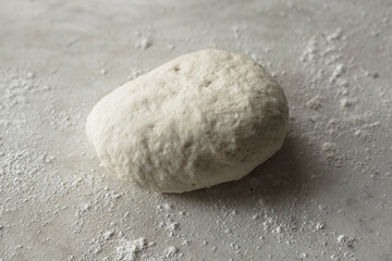 Fototapeta na wymiar rolled dough for making homemade bread in the oven